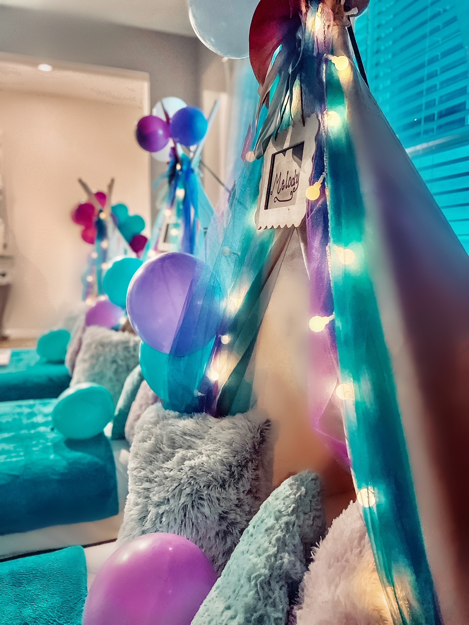 Purple and Teal embellished teepee themed tents with fairy lights and plush decorative pillows fairy lights