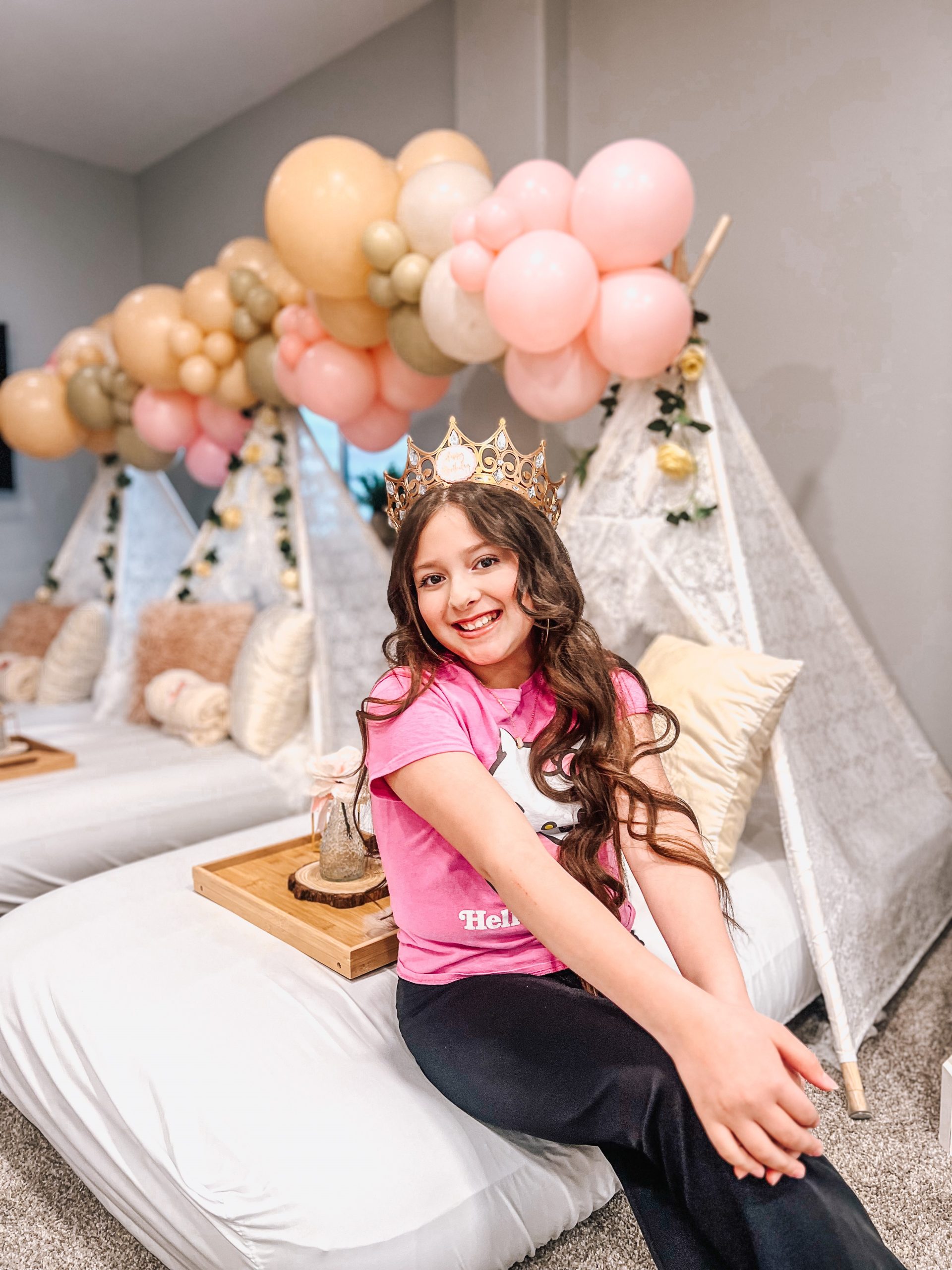 girl sitting on teepee bed