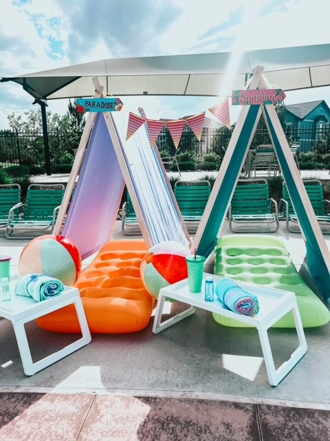 Colorful teepees set up by the pool, creating a vibrant and inviting atmosphere for a poolside cabana experience